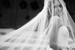 Bridal Portrait with veil blowing in the wind at Good Shephard Church in Colleyville