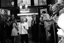 boy trying to eat bubbles at a wedding exit at the Room on Main in Dallas