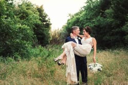 Groom Holding Bride In Field At The Laurel Grapevine