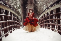 Moody Snow Portrait Girl In Red Dress Crossing Bridge