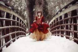 Moody Snow Portrait Girl In Red Dress Crossing Bridge